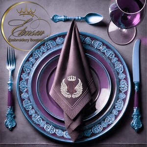 May include: A purple and blue patterned dinner plate with a smaller purple plate on top. A brown napkin with a white embroidered letter G and a crown is placed on the smaller plate. A silver fork and knife are on either side of the plate.