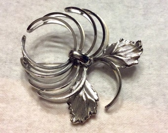 Silver metal floral flower hurricane brooch pin