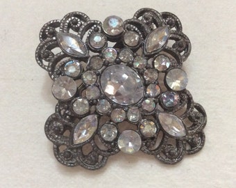 Vintage 1950s pot metal rhinestone hurricane brooch pin.