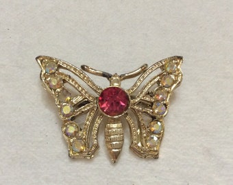 Vintage rhinestone gold colored metal butterfly brooch.