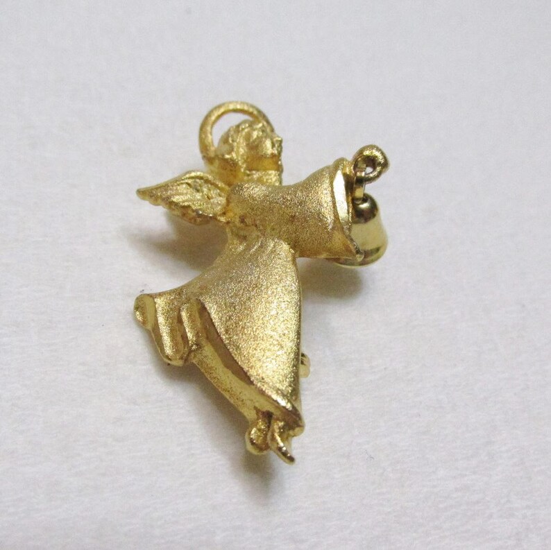 vintage 1970s gold toned metal angel with bell brooch pin