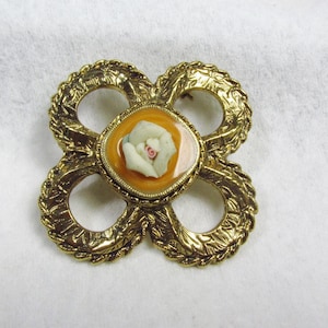 Porcelain rose epoxy enamel hurricane brooch pin.