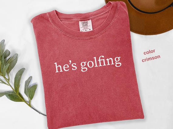 Comfort Colors® He's Golfing Shirt, Golfing Season Shirt, Golfer Wife Shirt, Golfing Mom Shirt, Golf Player Shirt for Mom, Golf Lover, t944