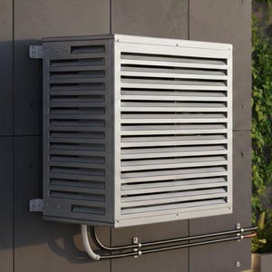 May include: A silver air conditioning unit fixed to a grey concrete wall. The unit features horizontal slats and is connected to pipes. The background includes a window with a city view and greenery.