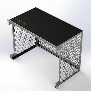 May include: A small, modern desk with a black top and a silver metal frame. The sides of the frame feature a honeycomb pattern. The desk has a rectangular shape and is designed for a compact space.