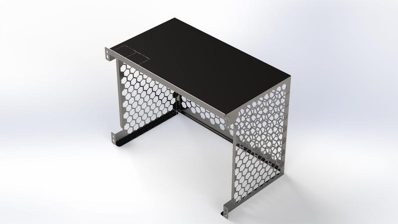 May include: A small, modern desk with a black top and a silver metal frame. The sides of the frame feature a honeycomb pattern. The desk has a rectangular shape and is designed for a compact space.