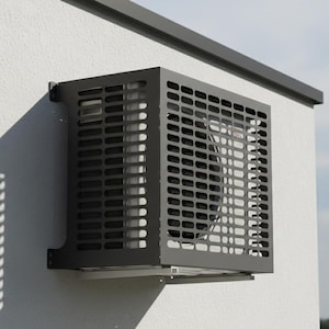 May include: A dark grey air conditioning unit mounted on a white stucco wall. The unit has a rectangular, perforated metal cover and is installed beneath a dark grey horizontal beam. The shadow of the unit is cast on the wall.