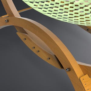 May include: Close-up of a wooden hammock frame with a light green woven seat. The frame is made of light-colored wood and features curved supports. Metal bolts secure the frame's components.