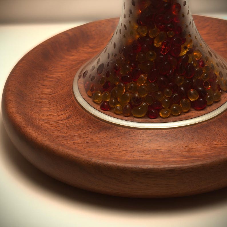 Close-up of the solid Huali wood base with a recessed tray, brass ring detail, and translucent decorative lamp body on a handmade table lamp.