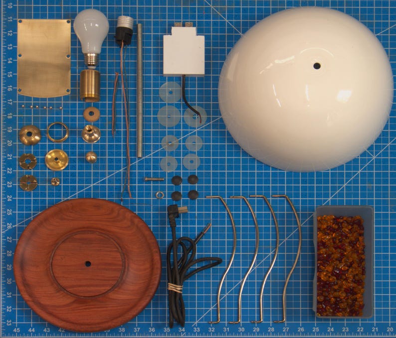 Disassembled view of the handmade bone china table lamp showing the bone china shade, Huali wood base, solid brass fittings, USB module, cord, and lamp components.