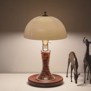 Handmade bone china table lamp glowing softly beside decorative deer figures, with a solid Huali wood base and dual USB ports.