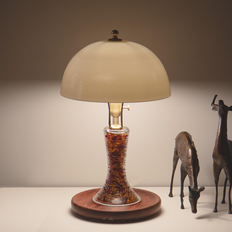 Handmade bone china table lamp glowing softly beside decorative deer figures, with a solid Huali wood base and dual USB ports.