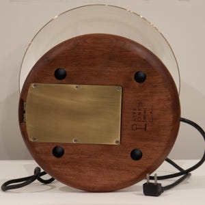 Bottom view of the handmade table lamp showing the Huali wood base, brass plate, rubber feet, USB ports, power cord, and maker’s mark.