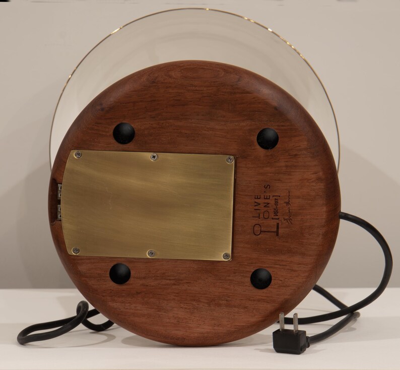 Bottom view of the handmade table lamp showing the Huali wood base, brass plate, rubber feet, USB ports, power cord, and maker’s mark.
