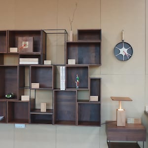 Modular Wall Shelving Unit, solid wood shelves, heat-blackened steel wall-mounted frame, minimalist storage for living room or office