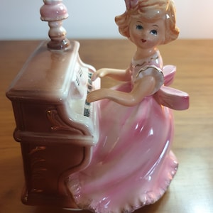Josef Original Music Box Figurine. Girl in pink dress sitting at her piano. Made in Japan.