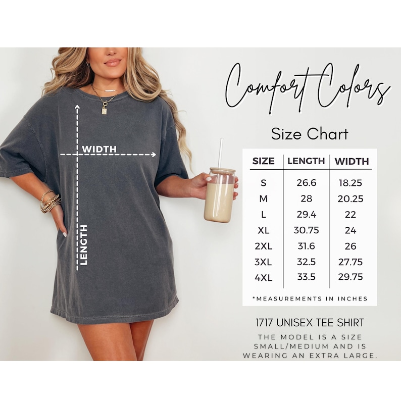 May include: A dark gray unisex tee shirt with a size chart. The size chart shows the length and width measurements in inches for sizes S to 4XL. The text on the shirt reads "1717 Unisex Tee Shirt". The model is wearing an extra large.