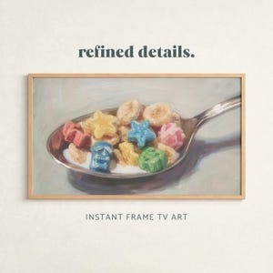 Könnte beinhalten: Gerahmter Druck mit einer Nahaufnahme eines Löffels voller Müsli und Milch. Die Müsliteile sind farbenfroh, mit Stern-, Schädel- und Kleeblattformen. Der Text "refined details" und "INSTANT FRAME TV ART" sind sichtbar.