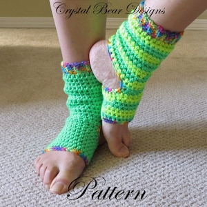 May include: A pair of green crochet ankle warmers with a multi-colored stripe detail. The ankle warmers are made with a crochet stitch and have a bright green and neon green color scheme. The ankle warmers are shown on a person's feet.