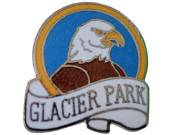 May include: A white and brown eagle with a yellow beak and yellow eyes is on a blue circle with a yellow border. The circle is on a white banner with the text "Glacier Park" in black.