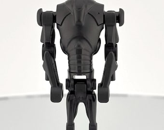 May include: A black plastic action figure of a robot with articulated arms and legs. The robot has a detailed design with a rounded head and a chest plate.