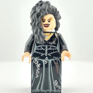 May include: A Lego figurine of a character with gray curly hair, wearing a black dress with white floral designs. The figurine has a stern expression with red lipstick and a necklace.
