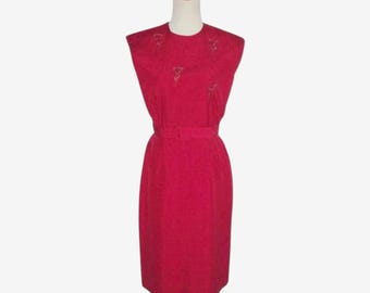 May include: A sleeveless, red dress with a fitted silhouette and a belt. The dress has a subtle textured pattern and features a decorative design on the neckline.
