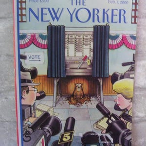 May include: The New Yorker magazine cover from February 7, 2000, features an illustration of a groundhog emerging from a voting booth, surrounded by reporters with microphones and cameras. The groundhog is wearing a brown fur coat and has a surprised expression on its face. The voting booth is decorated with red, white, and blue bunting. The cover also includes the text "The New Yorker" and "Feb. 7, 2000".