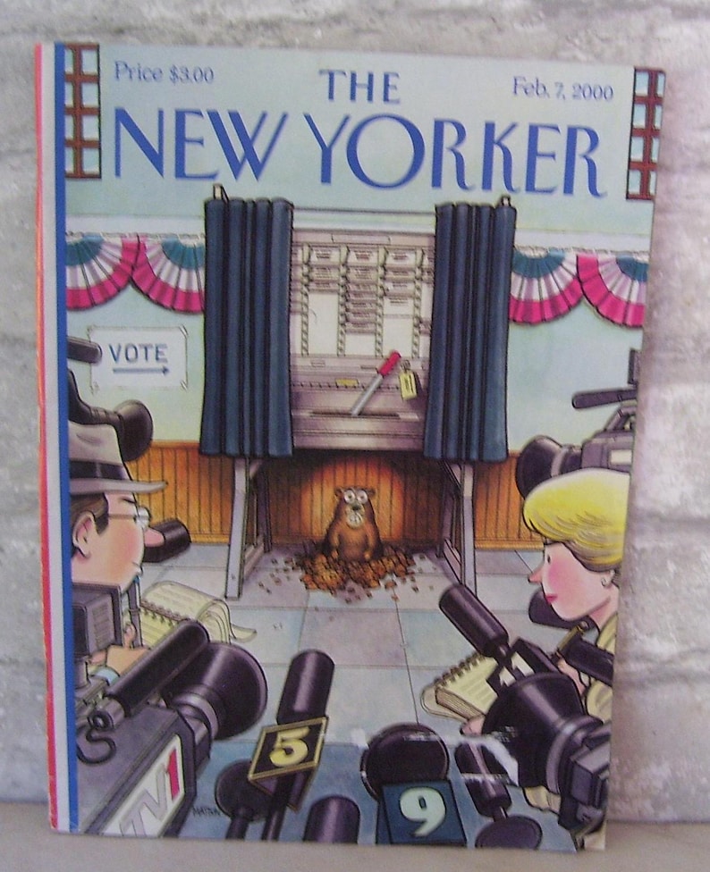 May include: The New Yorker magazine cover from February 7, 2000, features an illustration of a groundhog in a voting booth with reporters and cameras surrounding it. The cover depicts a humorous take on the Groundhog Day tradition.