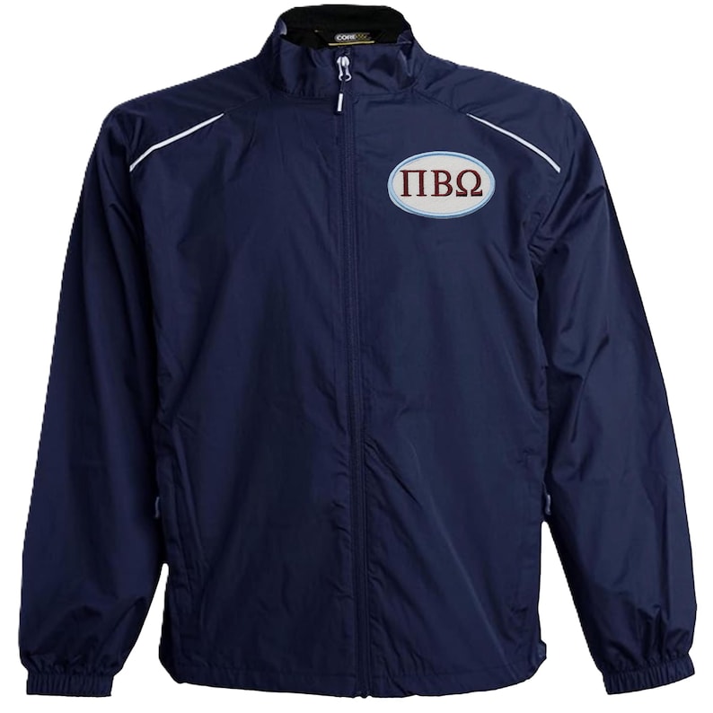 May include: A navy blue zip-up jacket with white shoulder trim and a small chest logo. The logo features the Greek letters &Pi;, I, and &Omega; in maroon. The jacket has a stand-up collar.