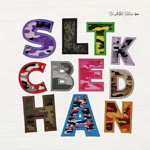 May include: A collection of colorful, embroidered fabric letters in various camouflage patterns. The letters include purple, black, green, pink, gray, brown, blue, and orange. The text "Two Artful Sisters" is in the top right corner.