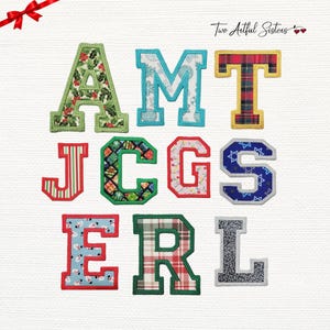 May include: A collection of ten fabric letters featuring various holiday-themed patterns including holly, plaid, snowflakes, Christmas lights, and snowmen. Each letter is outlined with a thick, stitched border in a coordinating color.