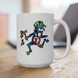 May include: A white ceramic mug featuring a colorful tie-dye patterned graphic of a stylized figure holding a musical note. The figure appears to be dancing or moving, with additional small musical notes floating nearby in a vibrant multi-colored design.