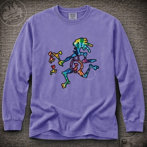 May include: A long-sleeve purple crewneck shirt featuring a central graphic of a tie-dye colored, stylized running figure with spiky hair, holding a small tool and surrounded by three small, floating, tie-dye colored musical note symbols.
