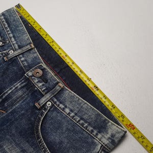 May include: A set of three ceramic mugs with a speckled, matte finish. The mugs are in shades of cream, light gray, and dark gray. Each mug has a simple, minimalist design, perfect for coffee or tea.
