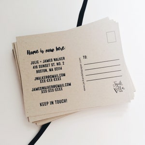 May include: A brown kraft paper postcard with the text "Home is now here:" and contact information for Julie and James Walker. The postcard also includes the website address "www.jackandellapaper.com" and the text "TO:" with a blank space for writing. The bottom right corner of the postcard has a logo for "Jack and Ella Paper."