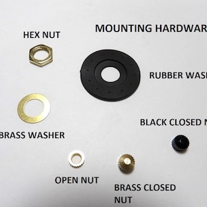 May include: Assortment of mounting hardware for a switch or knob, including a hex nut, brass washer, rubber washer, black closed nut, open nut, and brass closed nut.