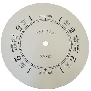 May include: White tide clock face with black markings. The clock face reads "High Tide", "Low Tide", "Tide Clock", "Quartz", "Hours Past High", "Hours To High", "Hours Past Low", "Hours To Low", "Rising Half Tide", and "Falling Half Tide".