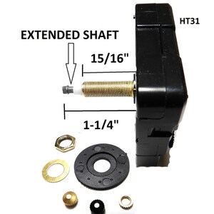 May include: Black clock movement with an extended shaft, labeled "HT31" and "EXTENDED SHAFT". The shaft measures 1-1/4" long and 15/16" in diameter. The movement comes with a black plastic gear, a gold washer, a gold nut, a gold crown, a black crown, and a gold washer.