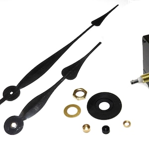 May include: A black clock movement kit with two black clock hands, a black washer, a gold washer, a gold nut, a gold pin, and a black pin.