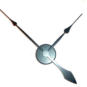 May include: Black clock hands with a black center disc. The hour hand is longer than the minute hand.