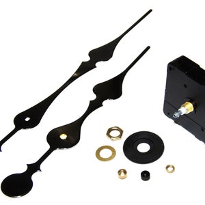 May include: Black clock hands and a black clock movement kit with gold-colored hardware. The kit includes a black washer, a gold-colored washer, a gold-colored nut, a black nut, and a gold-colored pin.