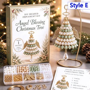 May include: A DIY beaded ornament kit for an Angel Blessing Christmas Tree, including a box with text, a clear plastic organizer with white, gold, and green beads, gold angel wings, a star, and a finished ornament on a gold metal stand.
