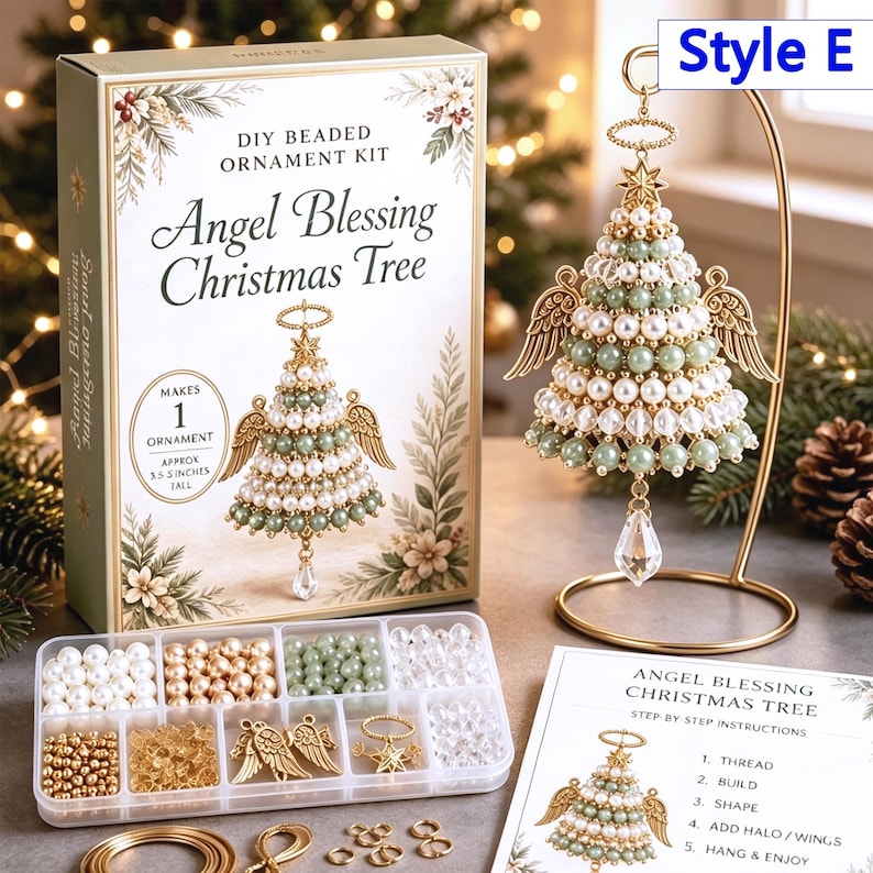 May include: A DIY beaded ornament kit for an Angel Blessing Christmas Tree, including a box with text, a clear plastic organizer with white, gold, and green beads, gold angel wings, a star, and a finished ornament on a gold metal stand.
