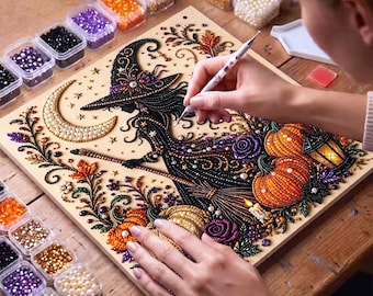 May include: A diamond painting kit featuring a witch silhouette, a crescent moon, pumpkins, and floral elements. The design is composed of colorful resin beads applied to a board, accompanied by small containers of beads and a stylus tool.