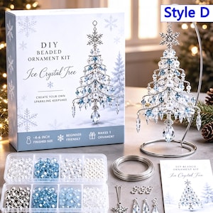 May include: A DIY beaded ornament kit for an Ice Crystal Tree, including a box with product text, a finished tree ornament on a silver stand, a clear plastic organizer with blue, white, and silver beads, silver wire, and an instruction booklet.
