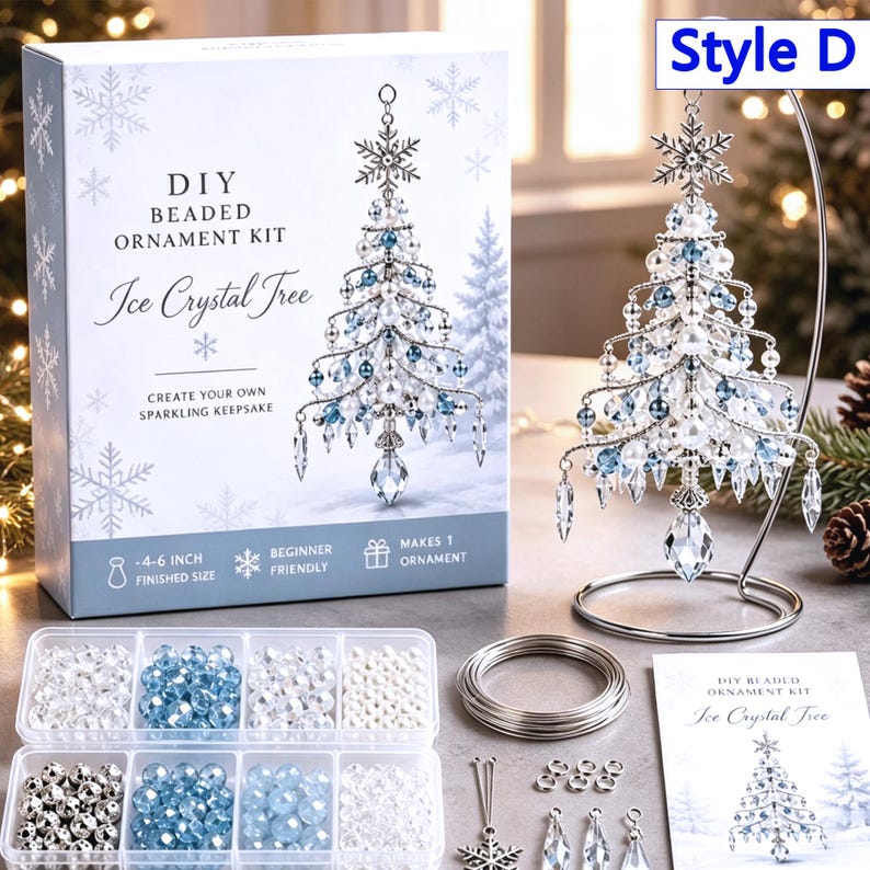 May include: A DIY beaded ornament kit for an Ice Crystal Tree, including a box with product text, a finished tree ornament on a silver stand, a clear plastic organizer with blue, white, and silver beads, silver wire, and an instruction booklet.