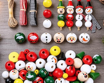 May include: A craft kit containing wooden beads in red, white, green, and yellow, including painted faces of Santa, snowmen, and elves. The set features spools of twine, red and white striped ribbon, and black and white gingham ribbon for assembly.