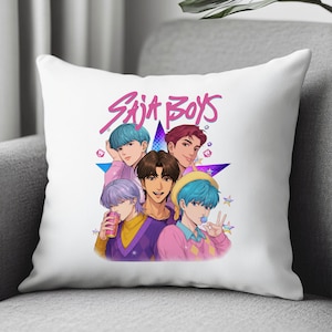 May include: White throw pillow featuring a colorful illustration of five anime-style characters. The pillow has the text "SAJA BOYS" in pink, with a star and small star accents.