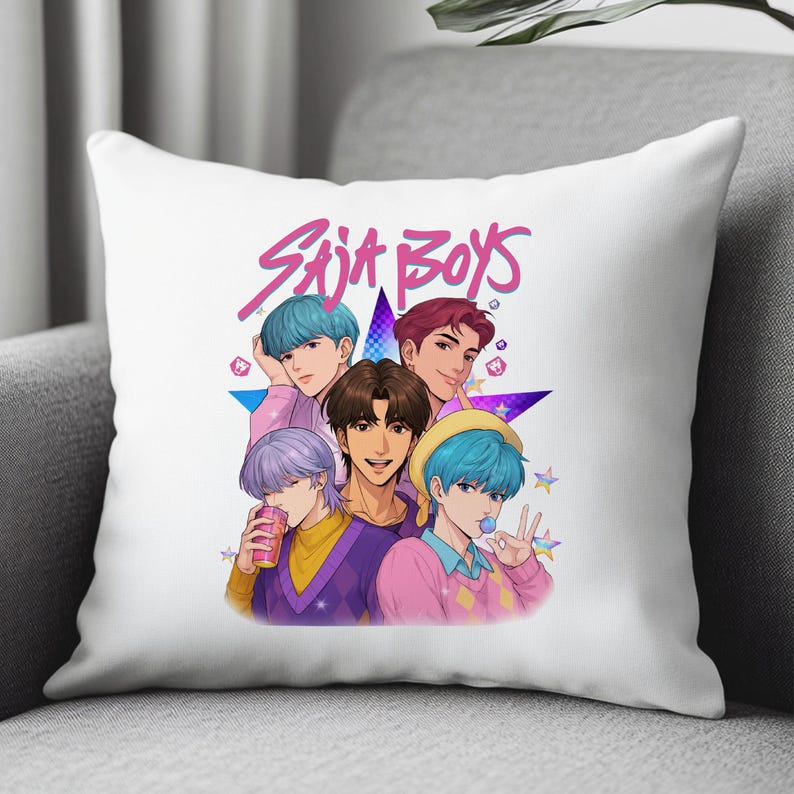 May include: White throw pillow featuring a colorful illustration of five anime-style characters. The pillow has the text "SAJA BOYS" in pink, with a star and small star accents.
